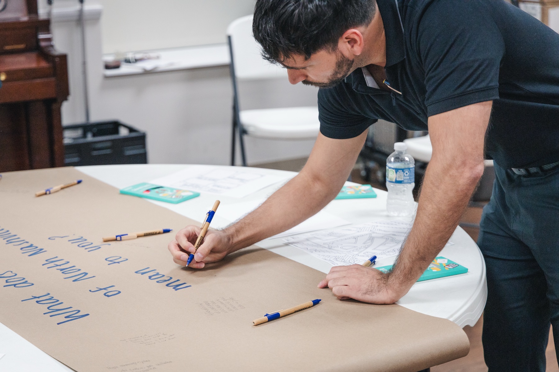 Workshop participant contributing ideas during an engagement activity