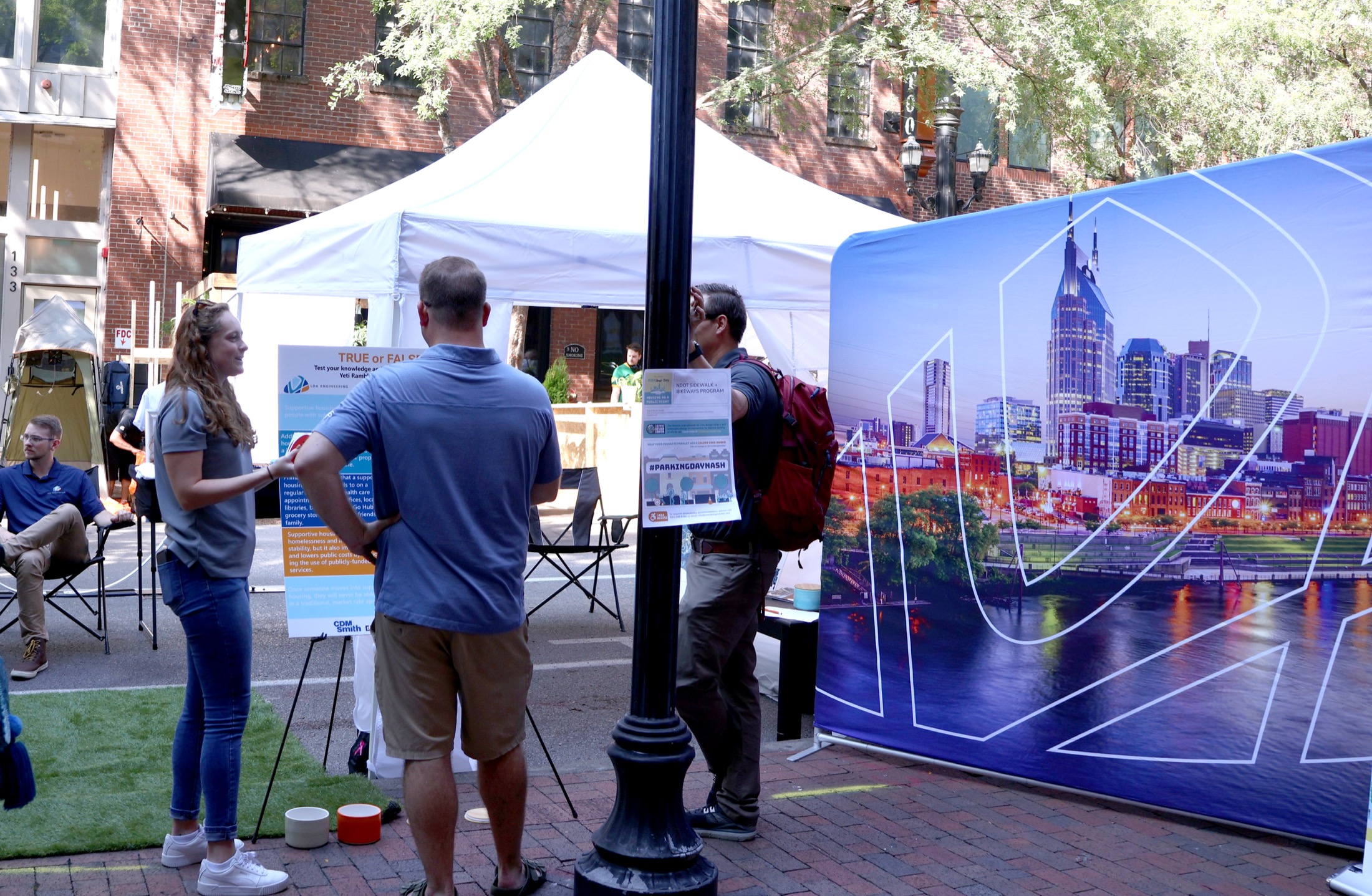 Project staff speak with a community member at an NDOT sidewalk and bikeway engagement booth.